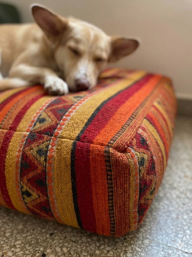 Moroccan leather pouf styled in a tactile interior with warm linen textures